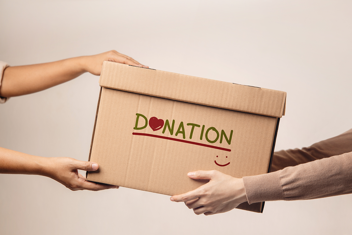 Hands exchanging a donation box.